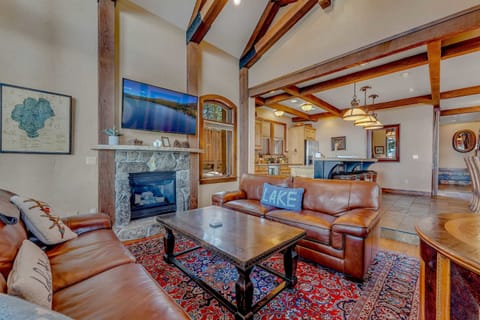 Living Room: 2 leather couches, 50” Smart TV, gas fireplace w/stone mantle, open layout to the kitchen