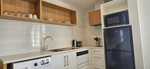 Premium 1 Bedroom Apartment | Private kitchen | Full-size fridge, microwave, stovetop, dishwasher