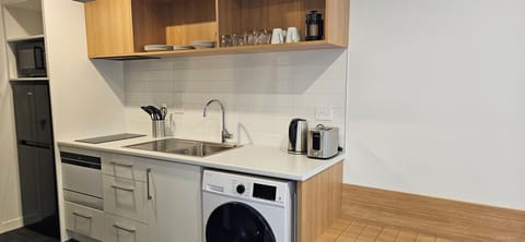 Premium Studio Apartment | Private kitchenette | Full-size fridge, microwave, stovetop, dishwasher