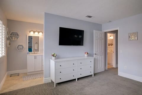 50" Roku TV in master bedroom with full bathroom.