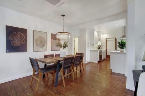 Dining area with crystal chandelier opens to kitchen for easy entertaining