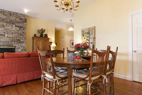 Contemporary dining space with a table that seats six, set against bold accent walls—perfect for family dinners or game night gatherings.