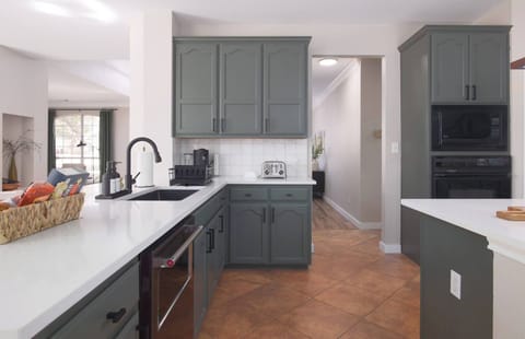 Our kitchen has all the essentials: toaster, coffee maker, microwave, oven, and sink. Perfect for cooking or enjoying your coffee.