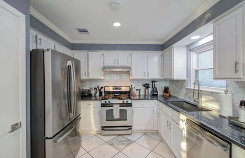 With plenty of counter space, lots of space for movement, and stainless-steel appliances, this kitchen is functional, spacious, and pretty to look at.