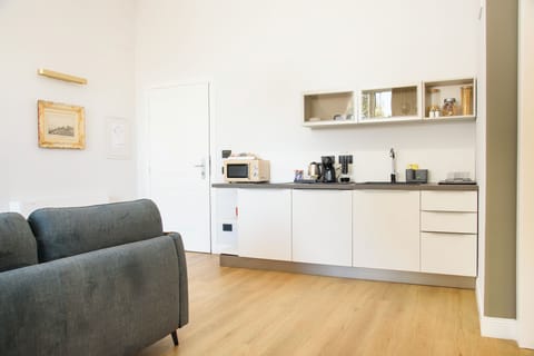 Deluxe Apartment | Private kitchen | Mini-fridge, coffee/tea maker, electric kettle, dining tables