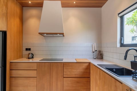 Villa | Private kitchen | Fridge, highchair, dining tables