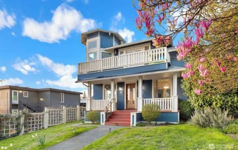 Step into a world of historic elegance and modern comfort with this stunning Victorian-style home, boasting a striking blue exterior complemented by crisp white trim and inviting red-accented steps. This home's picturesque architecture is enhanced by its expansive wraparound porch and a spacious second-floor balcony, offering breathtaking views and the perfect space for relaxat...