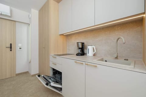 Bright entryway and kitchenette area – Modern, clean design.
