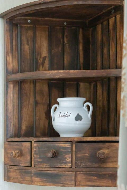 A rustic wooden shelf, showcasing unique decorative pieces, combining practicality with a warm, inviting design.
