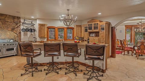 Main level kitchen with bar seating and adjacent dining area