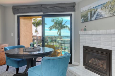 Nestled next to the fireplace, this charming two-person table offers the perfect spot for a cozy meal, a glass of wine, or a quiet moment with a good book.