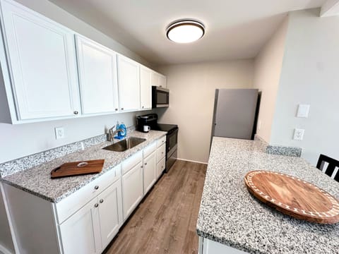 Deluxe Apartment, Beach View | Private kitchen | Full-size fridge, microwave, oven, cookware/dishes/utensils