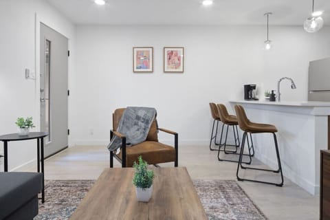 Prepare meals in this modern, fully-equipped kitchen featuring stainless steel appliances and a spacious island with bar seating. The open layout makes it easy to cook and entertain, ensuring a delightful culinary experience during your stay.