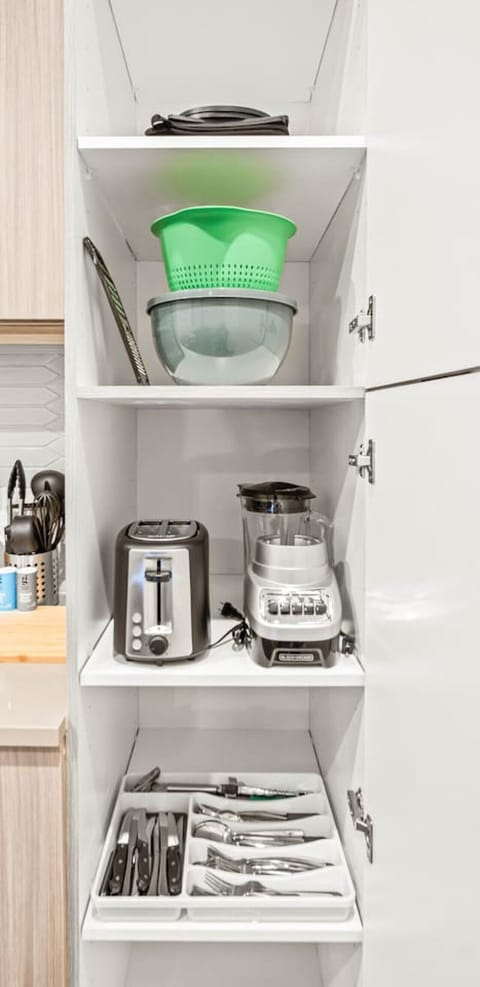 As you open the kitchen, you discover an assortment of coffee pods, and sugar, ensuring you have everything you need for a perfect morning or afternoon pick-me-up.