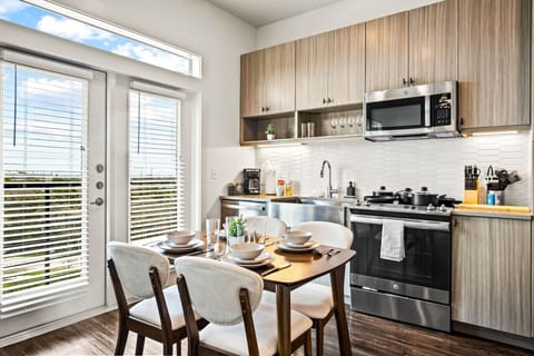 Set the table for memorable meals in this beautifully arranged dining area. With elegant place settings and a charming centerpiece, it's perfect for hosting dinner parties or enjoying family dinners in a cozy and stylish atmosphere.