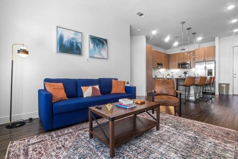 The living room is filled with natural light, creating a bright and welcoming space that invites relaxation.