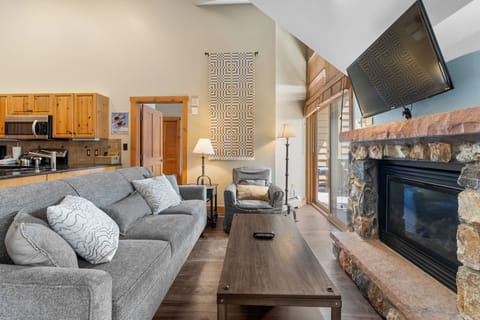 Living area with vaulted ceilings and flatscreen TV