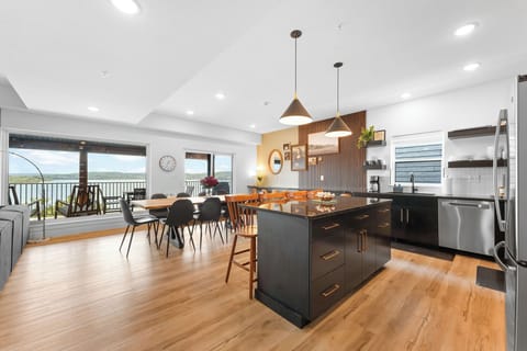 Step into the sleek kitchen and dining area, where stunning lake vistas welcome you and set the tone for every meal and moment.