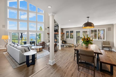 Main Floor: Open layout, kitchen, dining room, living room, soaring windows, impressive lake views