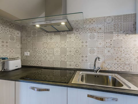 Flooring, Kitchen, Interior Design, Plumbing Fixture, Countertop, Floor, Sink, Tile, Tap, Cabinetry