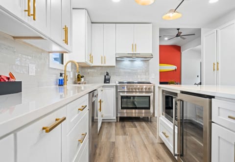 A closer look at the kitchen showcases the top-of-the-line appliances and sleek design—perfect for cooking up group meals.