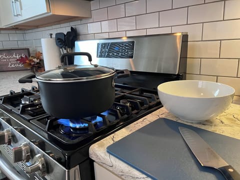 Fully equipped kitchen with cookware and dining ware