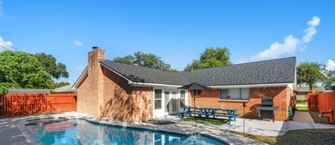 Gorgeous, shady backyard pool and patio provide a luxury Texan relaxation experience
