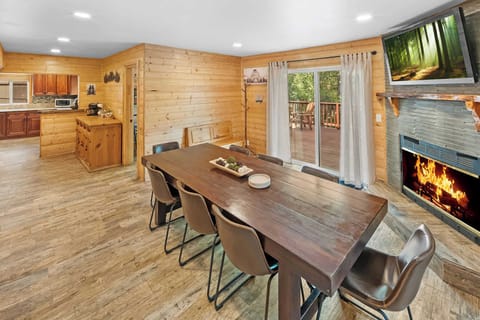 Plenty of seating for dining with fireplace and LCD Smart TV.