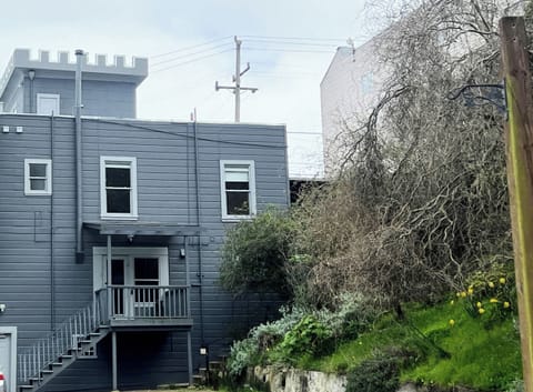 Private porch with view and stairs leading to backyard and park