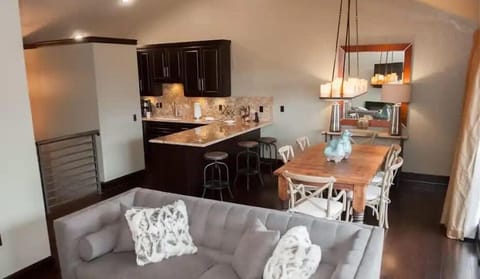 Cozy open-concept living space featuring a modern kitchen with a granite island and a warm dining area perfect for gatherings.