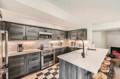 A chic, modern kitchen with breakfast bar seating