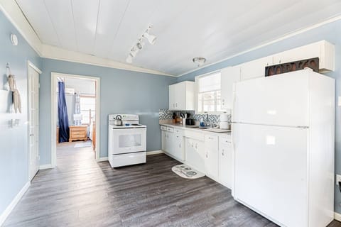 Our simple kitchen has an electric stove and all the cooking things you need. There is also a slow cooker.  The exterior has a BBQ grill on a propane tank.  Not shown is the coffee bar.