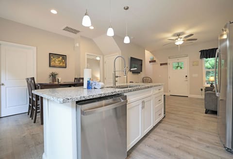Kitchen fully stocked with all the cooking essentials, stainless steel appliances, granite countertops, island seating.
