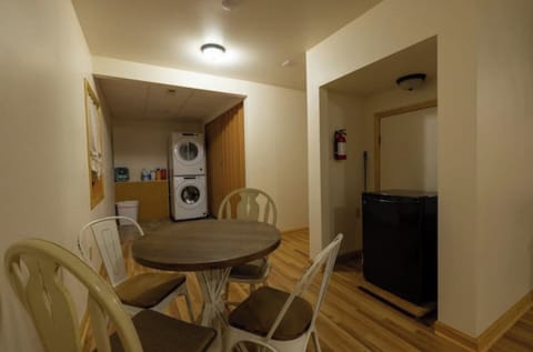 Lower level, full size stacking washer/dryer set. Seating area.