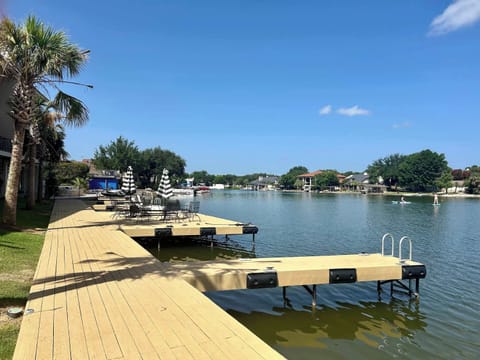 Waterfront deck area with patio tables and chairs