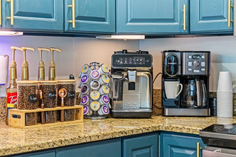 Indulge in a premium coffee experience with a fully stocked espresso bar—featuring a Philips automatic espresso machine, K-Cup, pot, french press, and a curated selection of beans, sugars, and syrups.