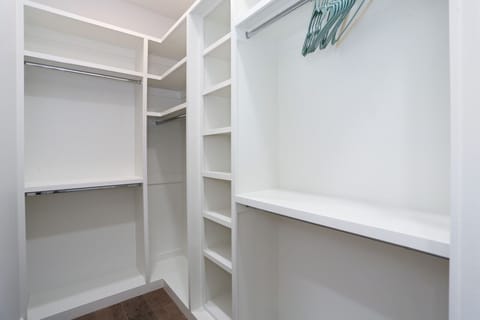 Spacious walk-in closet with ample shelving and hanging space for all your needs.