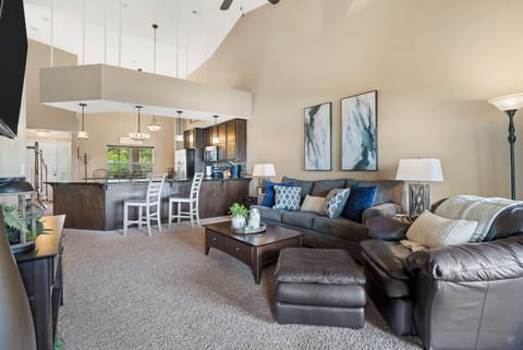 Living room with balcony access, sofa sleeper, and Smart TV