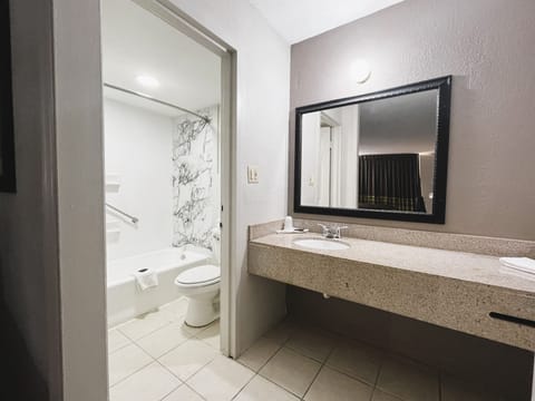 Deluxe Room, 2 Queen Beds | Bathroom | Combined shower/tub, rainfall showerhead, towels, soap