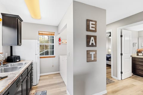 The cheerful kitchen offers ample space & all the comforts of home