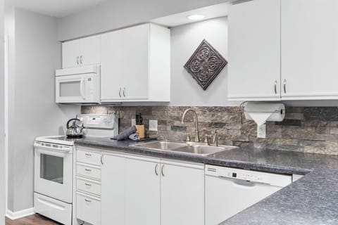 The airy, open kitchen is fully equipped with all the comforts of home