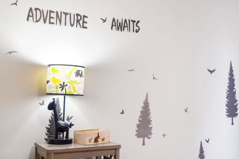 Kids will adore this camp-style bedroom with twin-over-full bunk beds & Smart TV