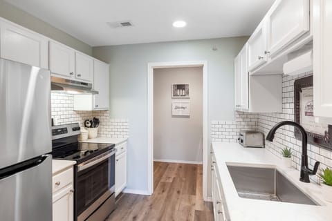 The airy kitchen offers ample space & all the comforts of home