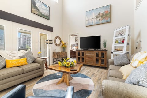 Spacious living room with balcony access TV, and Queen size sofa sleeper