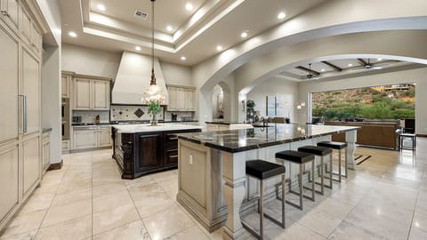 Expansive kitchen with dual islands, high-end appliances, and seamless flow.