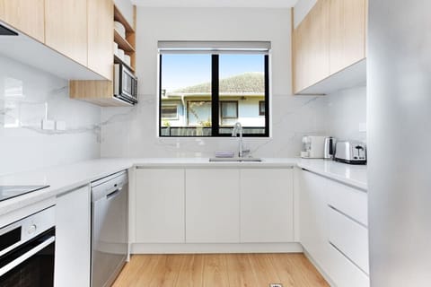 The kitchen has a cook top, oven, microwave, dishwasher and fridge/freezer.