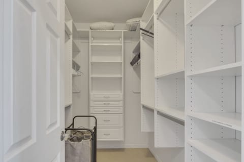 Step into luxury with our spacious walk-in closet, designed to accommodate your entire wardrobe with style