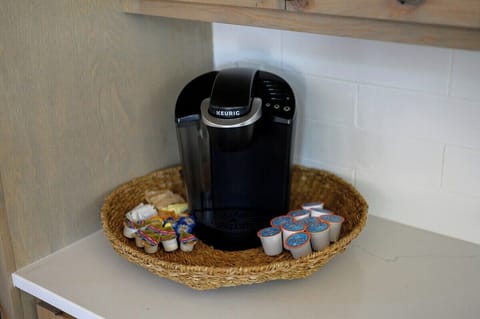 Keurig coffee station with assorted pods and creamers, ready to start your morning in comfort and style.