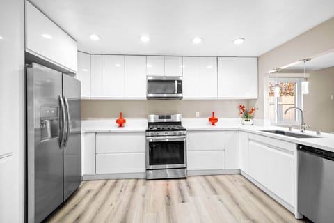 Cook like a pro in this modern kitchen, fully equipped with stainless steel appliances, sleek countertops, and ample storage