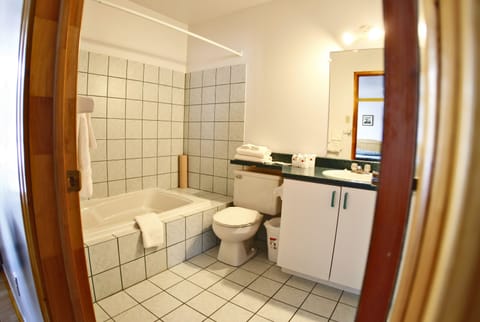 Quadruple Room, 2 Queen Beds | Bathroom | Combined shower/tub, free toiletries, hair dryer, towels